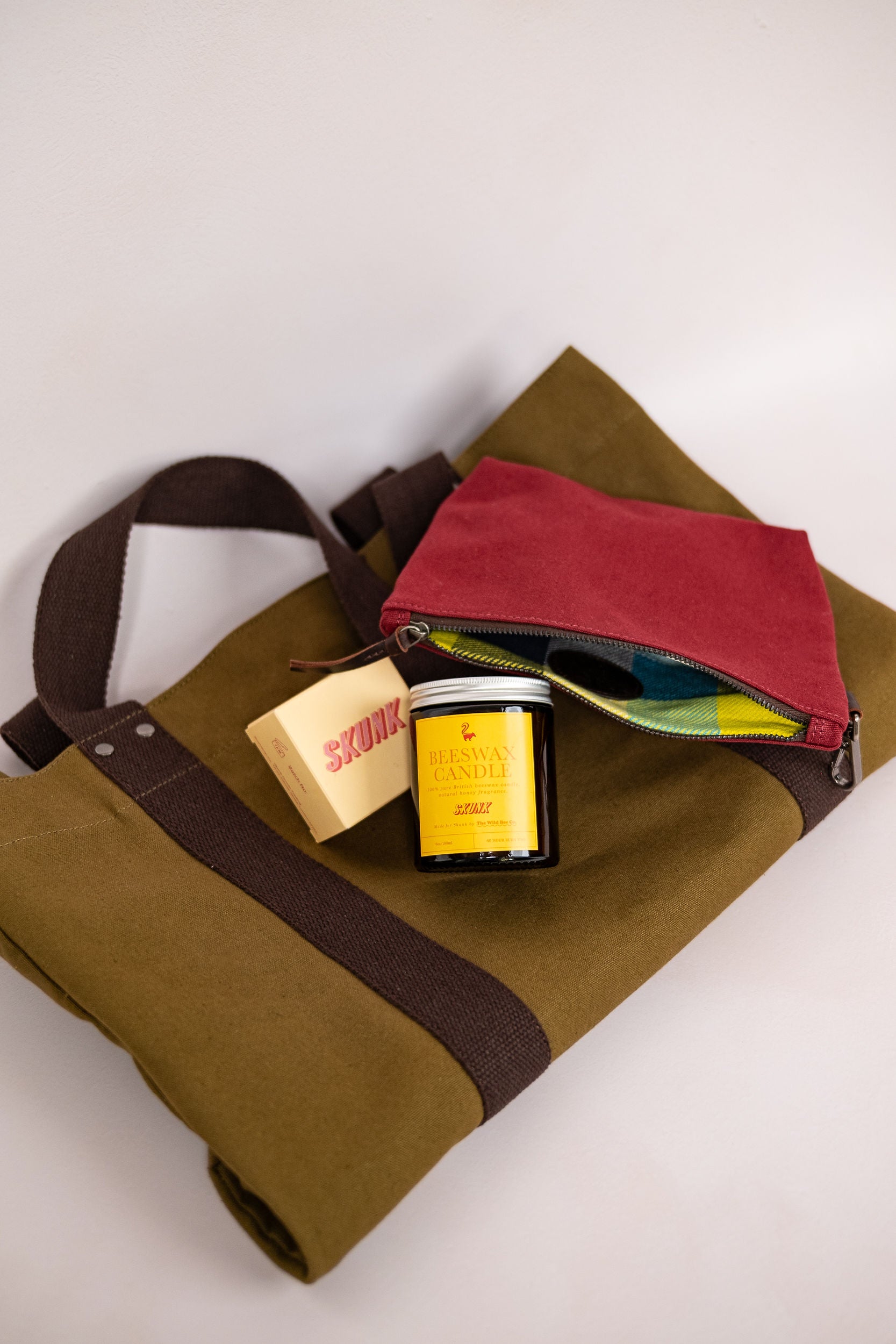 Gifting set featuring 100% bees wax candle, cold process bar of soap, canvas tote bag and the canvas pouch by Skunk Goods Trading