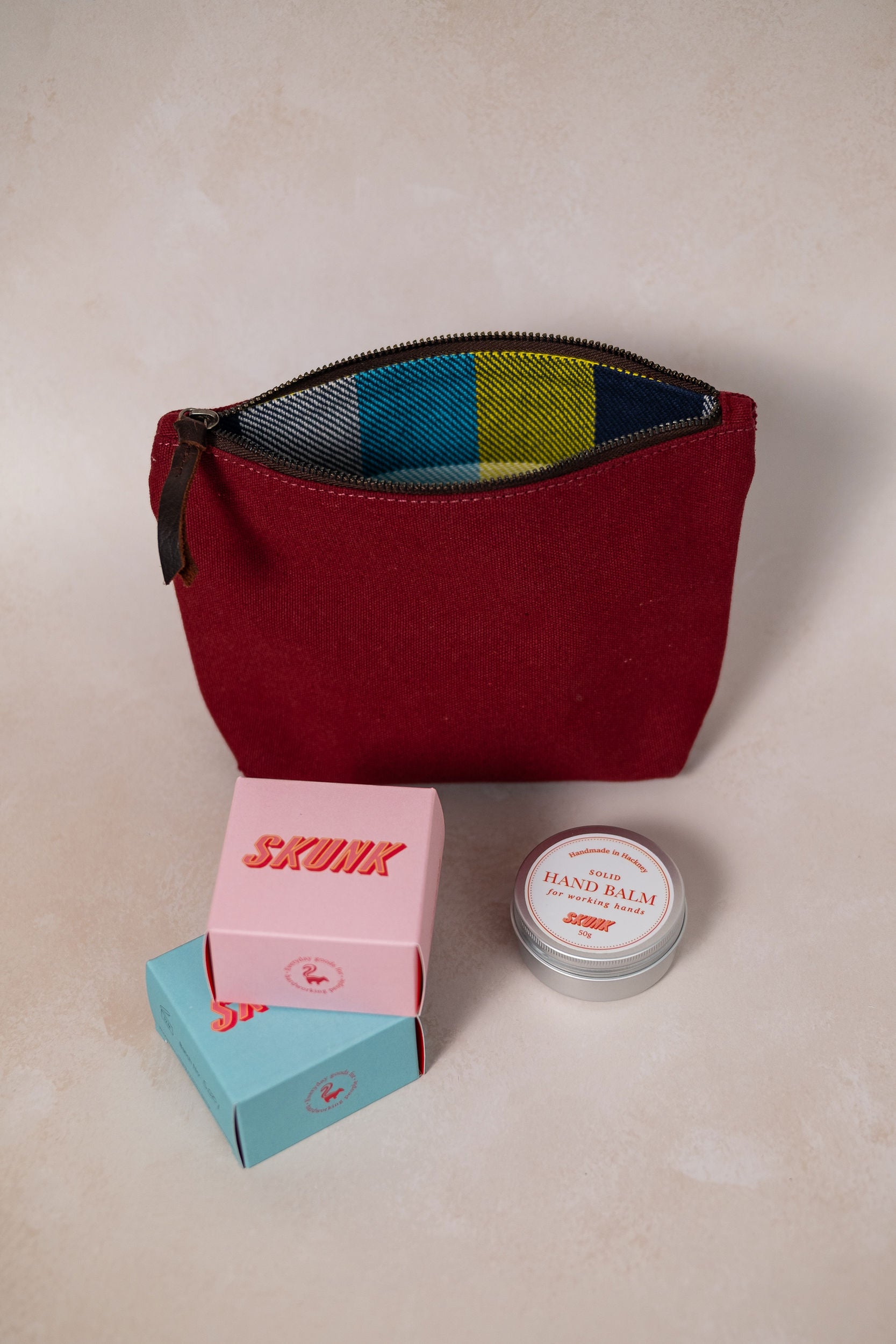 Maroon canvas pouch + soap + handbalm